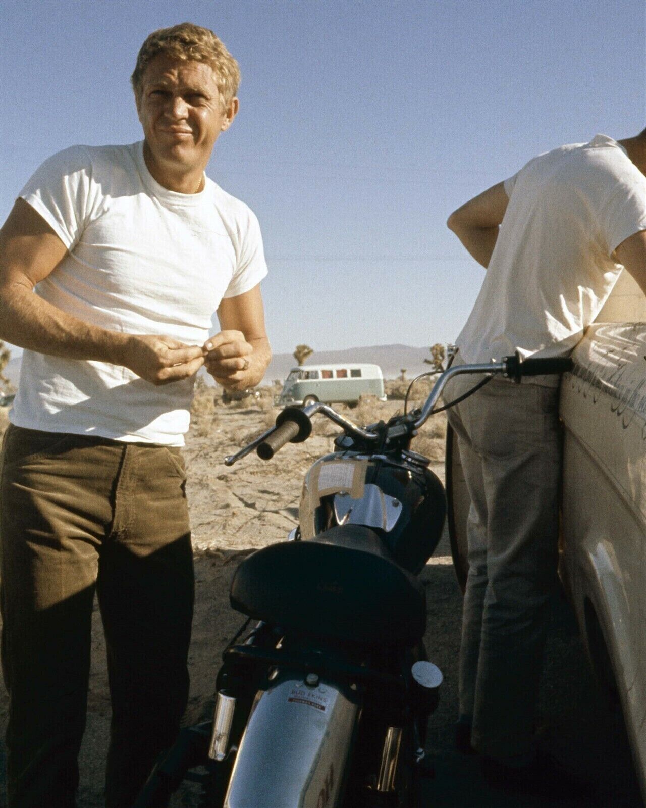Steve McQueen in white t-shirt stands next to bike in desert 1960\'s 5x7 photo