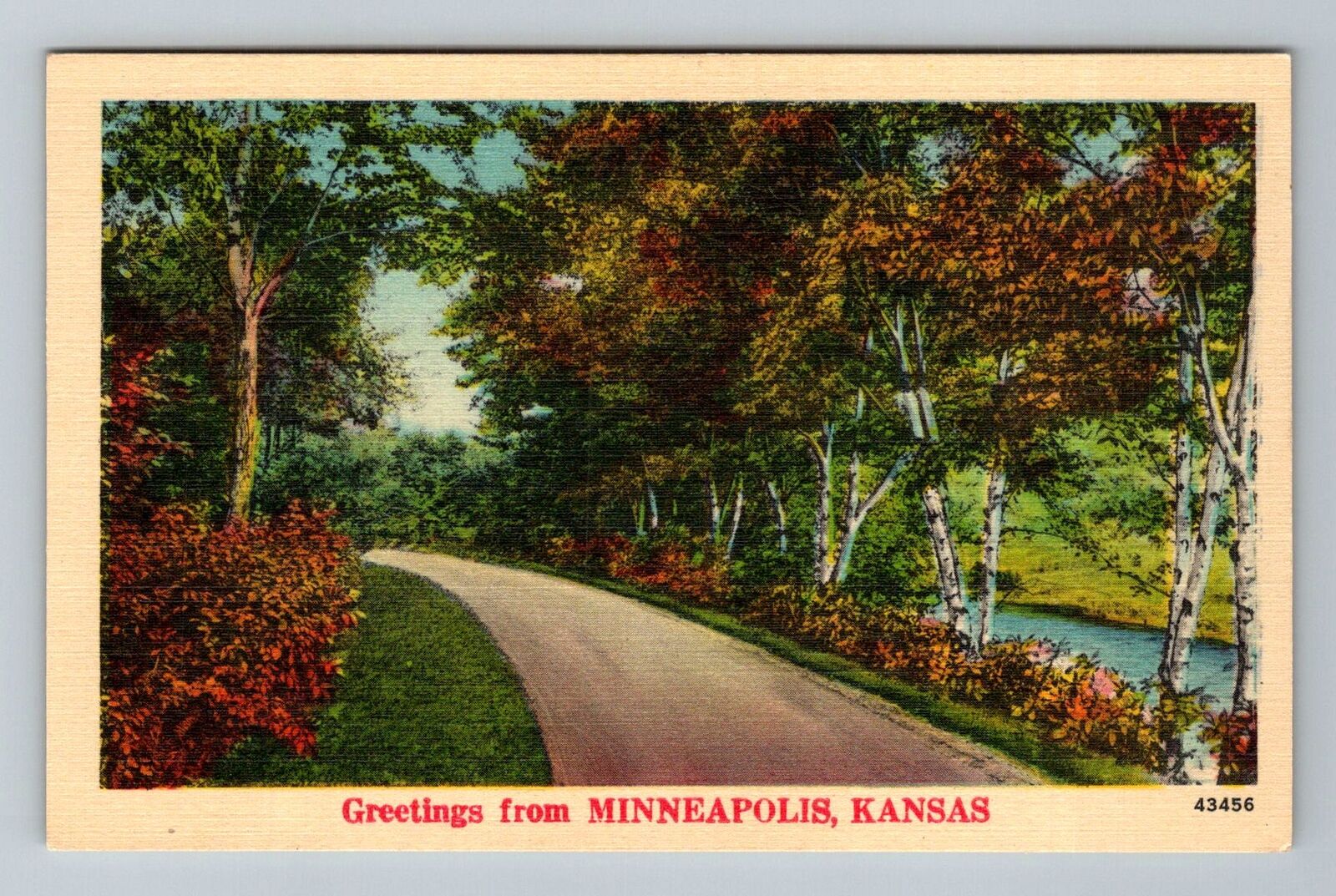 Minneapolis KS-Kansas Greetings Scenic Treelined Roadway Stream Vintage Postcard