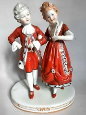 A charming porcelain figurine of a gallant couple is made in red colors Germany picture