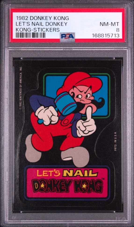 1982 DONKEY KONG STICKERS LET'S NAIL DONKEY KONG PSA 8