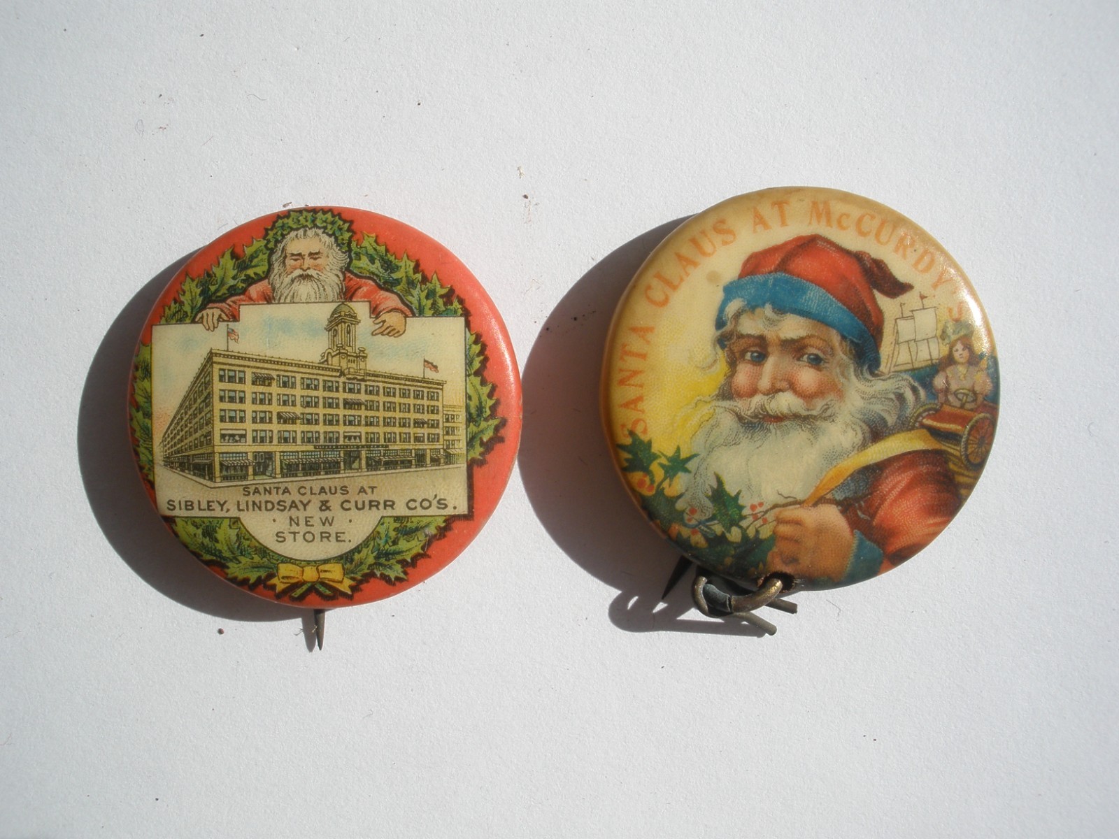 2 VTG Santa Christmas McCurdy’s & Sibley\'s Dept Store Celluloid Pinback button