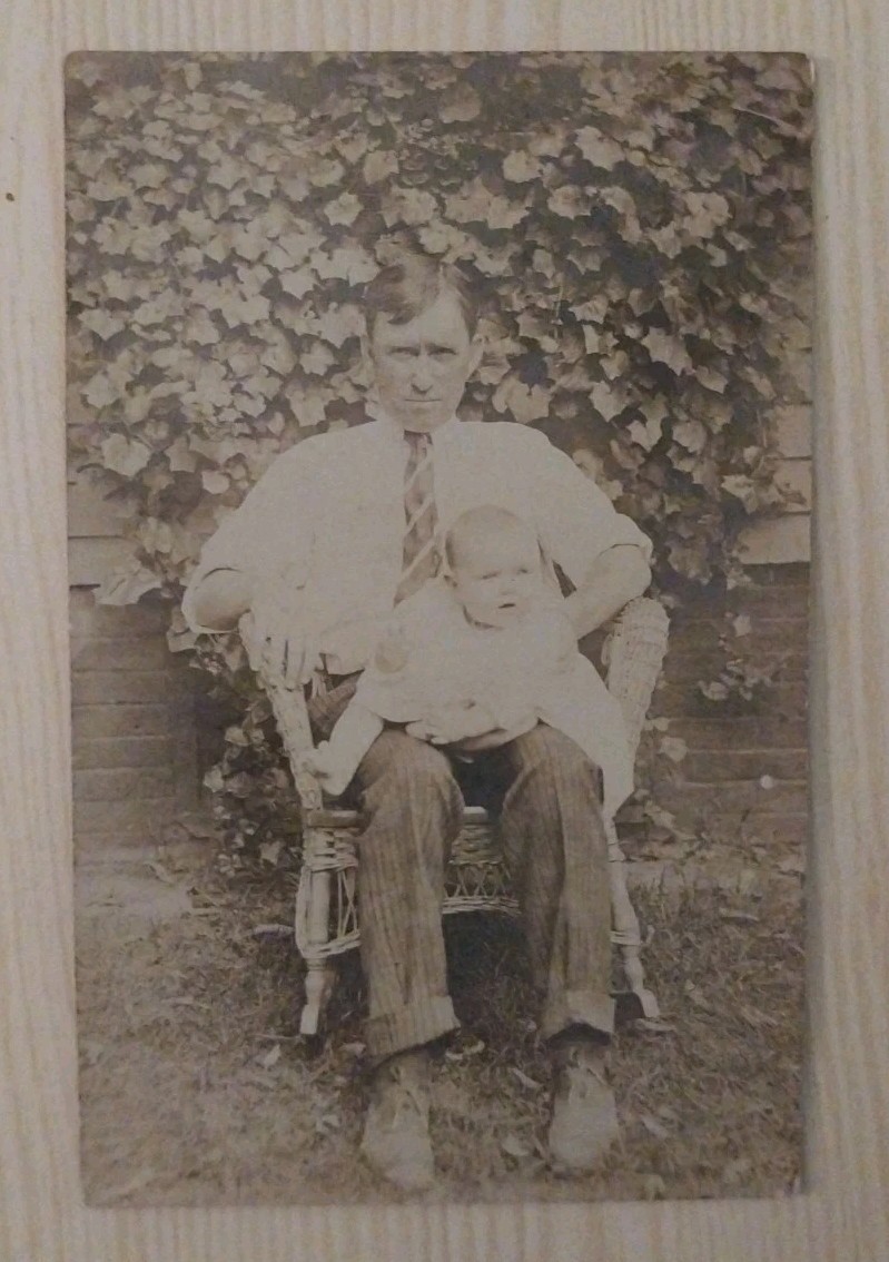 Vintage RPPC Postcard Man Holding Baby Wicker Chair Ivy Background Antique Photo