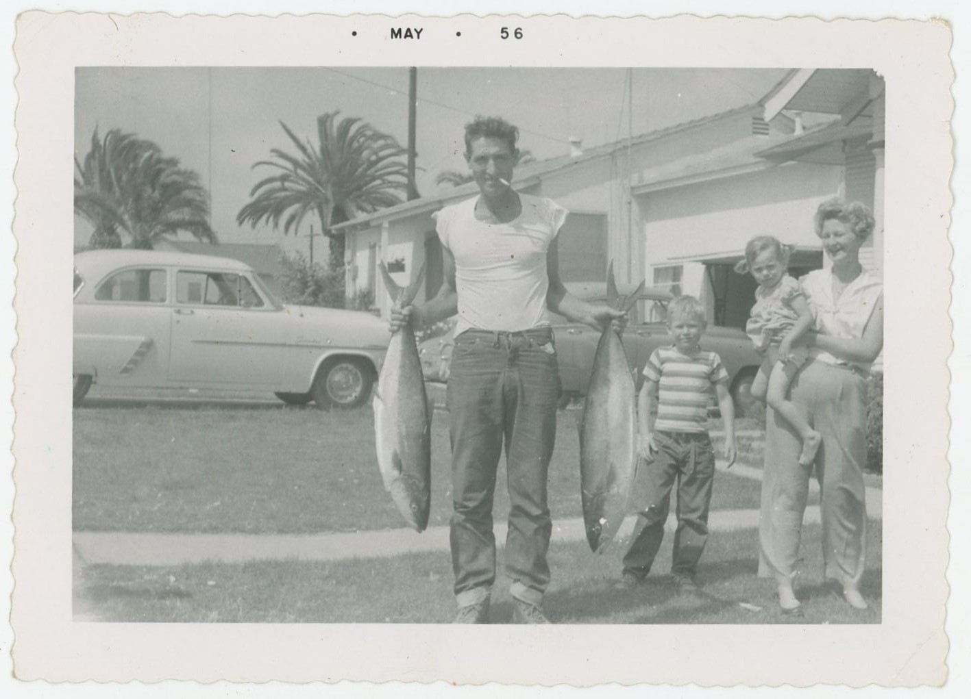 Man Holding Huge Fish Cigarette in Mouth Car Family Funny VTG Photo 1950s