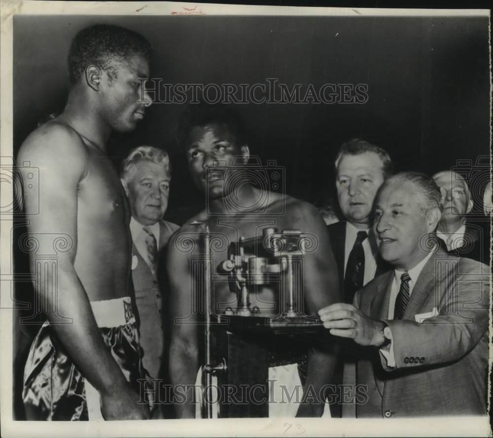1956 Press Photo Boxer Floyd Patterson weighs in for bout with Tommy Jackson