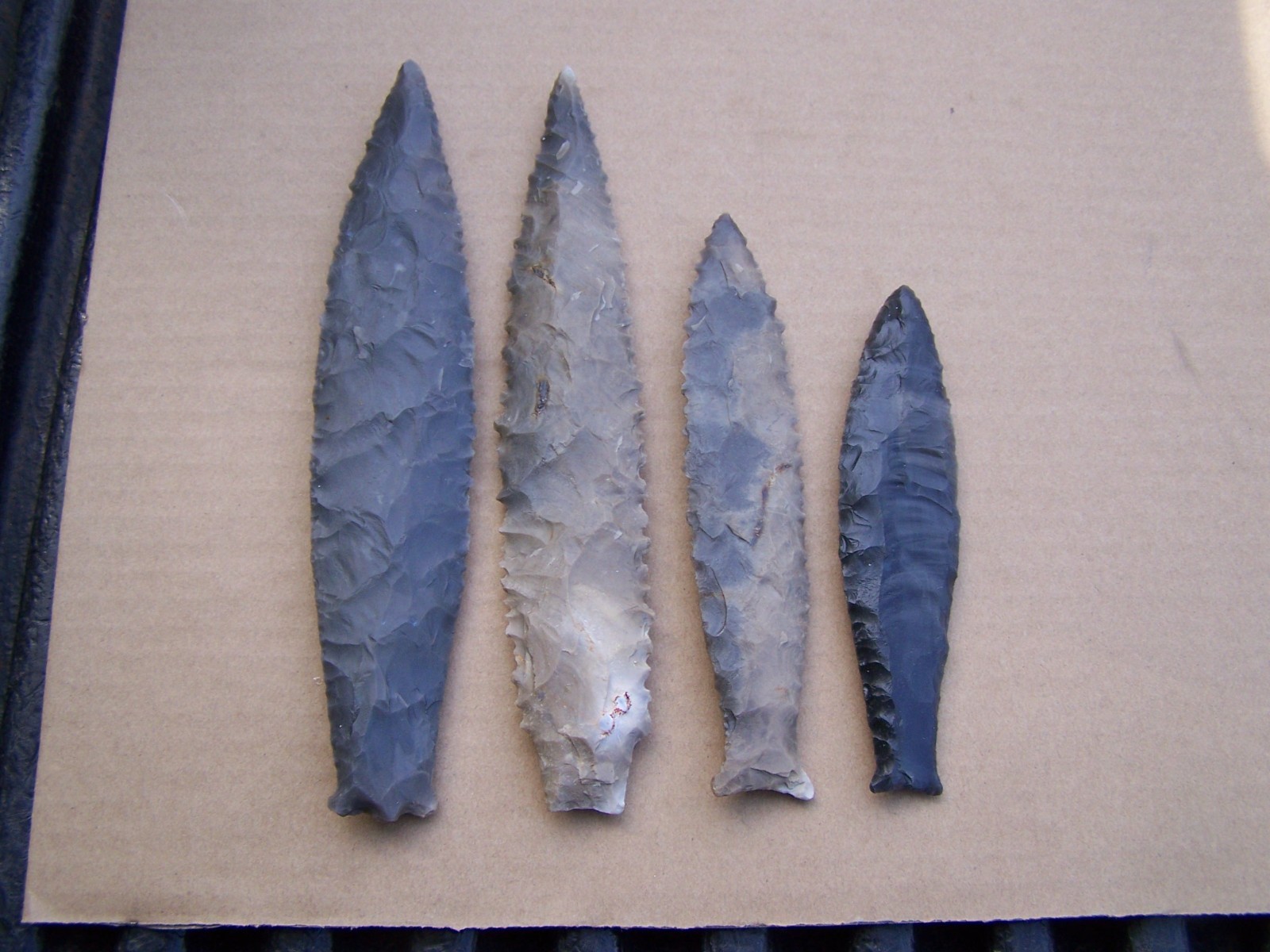 Here is a group of 4 reproduction arrowheads (Read listing)