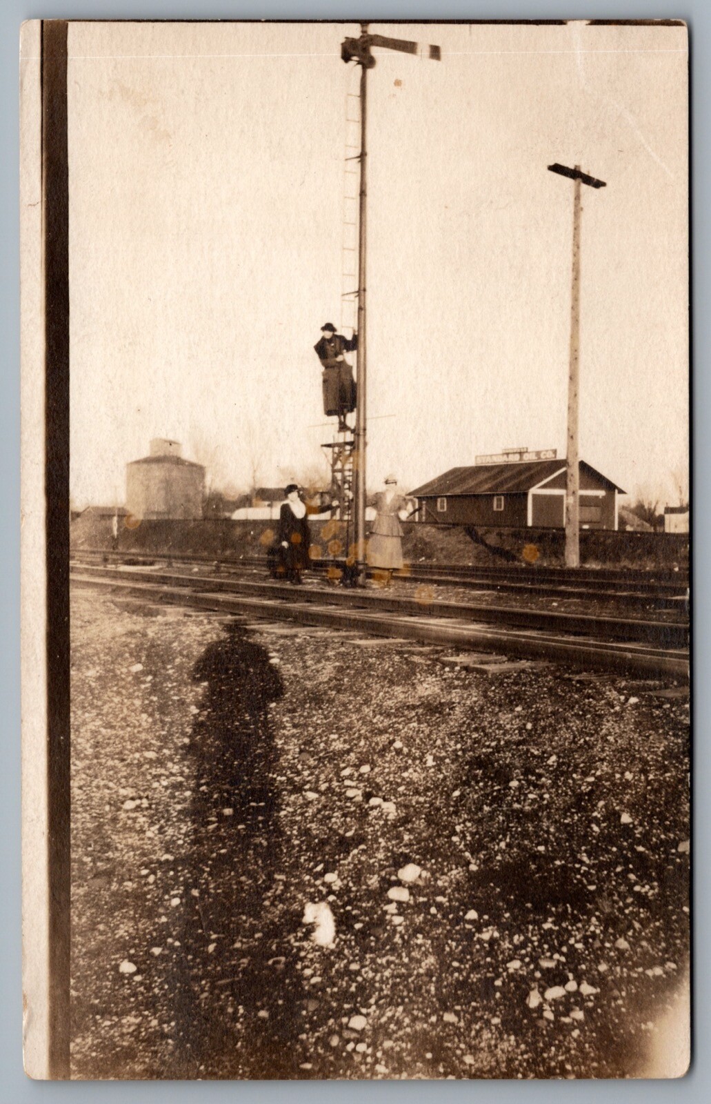 Postcard RPPC c1918 Ladies On Tracks Climbing Signal Tower Standard Oil Co. Sign