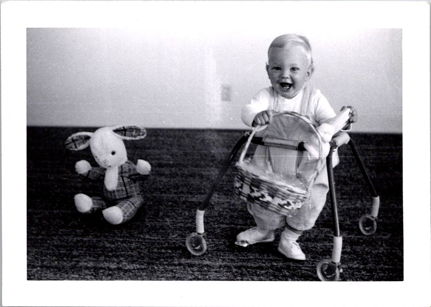 Joyful Toddler in Walker with Easter Basket, 1960s B&W Snapshot Photo