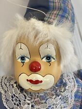 Beautiful Clown with Ceramic Painted Face Sitting on Swing Hangs from Ceiling picture