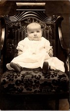 A Baby In White Dress Seated In Ornate Chair RPPC Real Photo Postcard 4P23-5 picture
