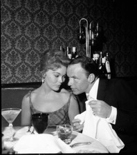 Singer Frank Sinatra has dinner with a woman in circa 1960 Old Photo picture