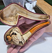 antique carved meerschaum pipe featuring a detailed hand holding a pinecone picture