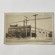 Antique RPPC Real Photograph Postcard Building Man Walking Across Street Poles picture
