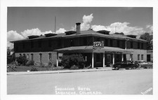 H33/ Saguache Colorado RPPC Postcard c1950s Saguache Hotel Café Autos picture