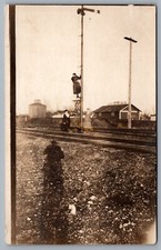 Postcard RPPC c1918 Ladies On Tracks Climbing Signal Tower Standard Oil Co. Sign picture