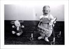 Joyful Toddler in Walker with Easter Basket, 1960s B&W Snapshot Photo picture