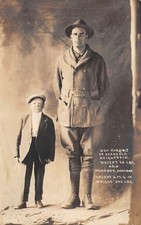 46 INCH MAN & 6 FOOT 6 INCH MAN POSE NEXT TO EACH OTHER, REAL PHOTO PC c 1910-20 picture