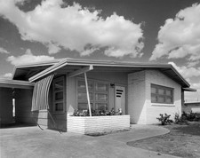 Exterior view of a ranch style house with clouds passing overhead Old Photo picture